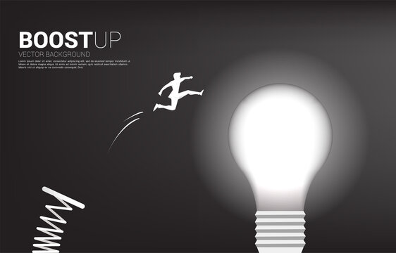 Silhouette Of Businessman Jump To Light Bulb With Springboard . Business Concept Of Creative Idea And Solution.