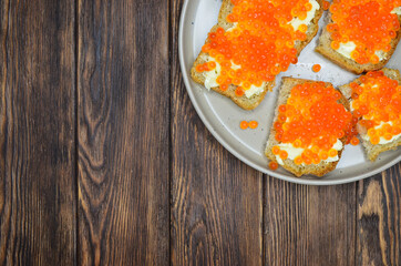 delicacy product red salmon caviar flat lay top view with copy space text on wooden table, healthy organic eco food concept