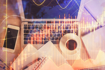 Stock market chart and top view computer on the table background. Double exposure. Concept of financial analysis.