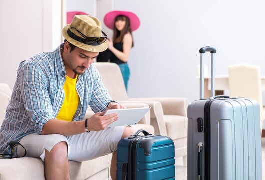 Young family packing for vacation travel