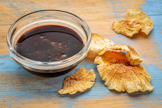 a small bowl of yacon syrup with dried slices of yacon tuber,  a powerful prebiotic sweetener derived from the yacon root