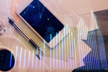 Multi exposure of forex graph hologram over desktop with phone. Top view. Mobile trade platform concept.