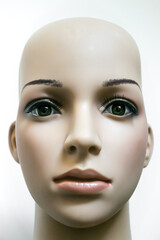 Bald mannequin's head on white background.