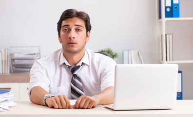 Young handsome businessman working in office