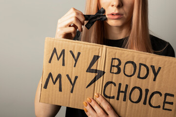 A woman protests against the ban on abortion in Poland. A feminist defends women's rights.