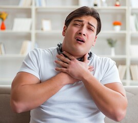 Young man suffering from sore throat