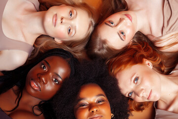 Obraz premium young pretty caucasian, afro, scandinavian woman posing cheerful together on brown background, lifestyle diverse nationality people concept