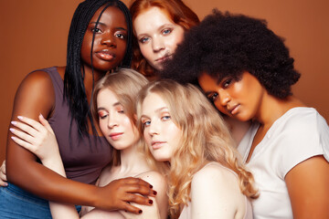 Obraz premium young pretty caucasian, afro, scandinavian woman posing cheerful together on brown background, lifestyle diverse nationality people concept