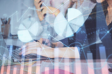 Multi exposure of woman hands typing on computer and financial graph hologram drawing. Stock market analysis concept.