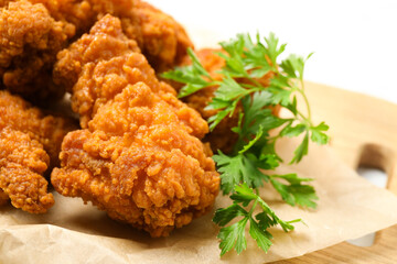 Tasty deep fried chicken pieces served on table, closeup