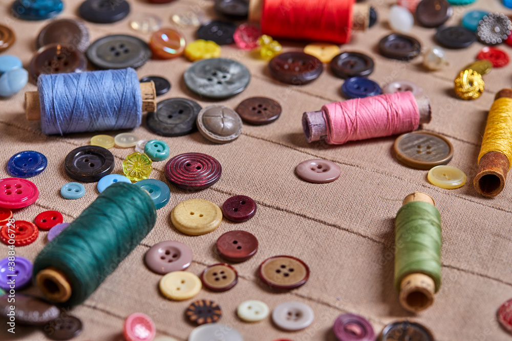 Poster background and texture of multicolored antique buttons and sewing tools