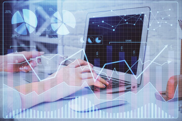 Double exposure of woman hands typing on computer and forex chart hologram drawing. Stock market analysis concept.