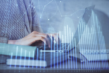 Double exposure of woman hands typing on computer and forex chart hologram drawing. Stock market analysis concept.