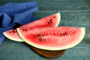 Fototapeta na wymiar Board with yummy watermelon slices on wooden table