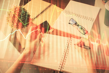 Multi exposure of woman on-line shopping holding a credit card and financial graph drawing. Stock market E-commerce concept.