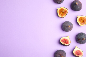 Delicious ripe figs on violet background, flat lay. Space for text