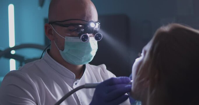 Dentist curing teeth of little patient