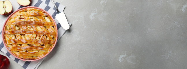 Traditional apple pie and space for text on light grey table, flat lay. Banner design