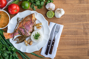 Roasted red fish (Olho de Cão in Brazil) seasoned with herbs, garlic, salt and lemon. Accompanying...