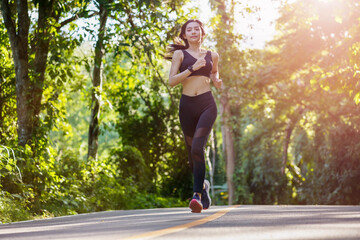 Beautiful young athletic girl running on summer morning in outdoors. Healthy lifestyle,Fitness training and Sport Concept.