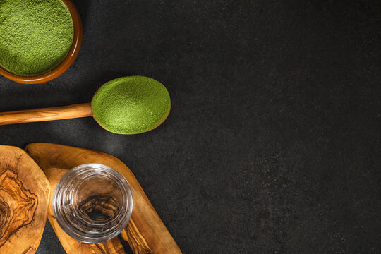 Freeze-dried wheatgrass powder, nutritional supplement on a tablespoon.