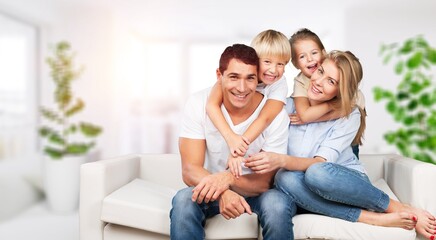Fototapeta na wymiar Beautiful smiling lovely family sitting on sofa