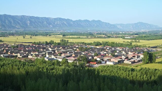 Panorama of rural landscape in Henan, China. Beautiful small village and farmland, mountain in the distance