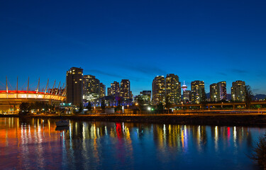 Vancouver city skyline at night, Brithish Columbia, Canada. Colorful reflections of city buildinsg in False Creek.