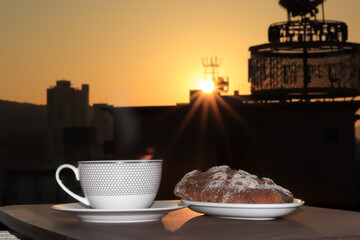 Coffee cup and breakfast cake with luxury hotel background