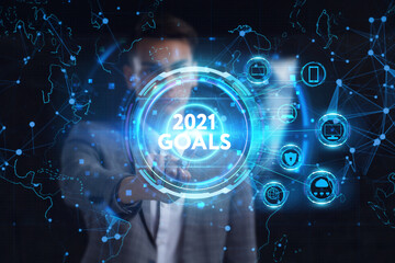 Business, technology, internet and network concept. Young businessman thinks over the steps for successful growth: 2021 goals
