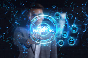 Fototapeta premium Business, technology, internet and network concept. Young businessman thinks over the steps for successful growth: Video marketing