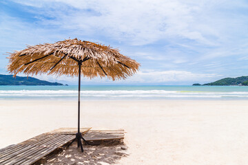 Beach Umbrella made of palm leafs on a perfect white beach in front of Sea, Thailand.