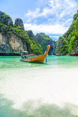 Thai traditional wooden longtail boat and beautiful beach at Thailand.