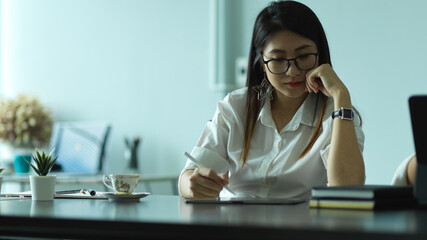 Female entrepreneur working with office supplies on office desk