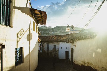 Old spanish architecture in cusco with a lamp post during sunset