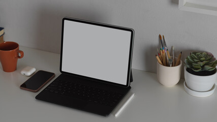 Workspace with mock up blank screen tablet on working table, clipping path