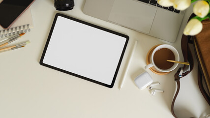 Workspace with tablet, laptop, accessories and supplies on white table, clipping path