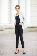 Obraz premium Portrait of a young beautiful girl in a business jacket