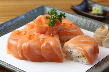 Top-view Happy birthday, Slice Salmon sushi cake on black background isolated