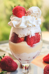 Bowl with cream and whipped cream with strawberries