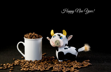 Toy white ox, zodiac sign lunar new year 2021 and roasted coffee beans