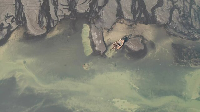 Top View Of FV Clyne Castle Steam Trawler Shipwreck In Breidamerkursandur, South Iceland - descending drone shot