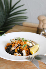 Black spaghetti pasta with seafood, tomatoes and basil