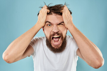 Bearded man emotions facial expression gestures hands close-up blue background
