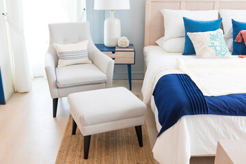 close up of new bed comfort with decorative pillows ,headboard and side table lamp.