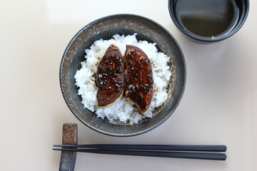 Foie Gras Don - A bowl of steamed rice topped with grilled goose liver topped with roe salmon on wooden table.top view
