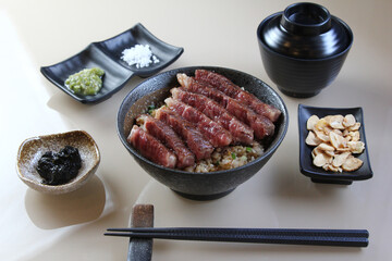 A piece of A5 Hida beef on top a rice bowl