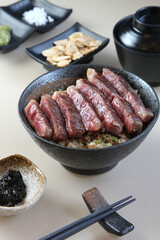 A piece of A5 Hida beef on top a rice bowl