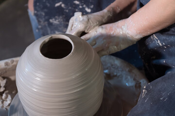 hands of potter at work on wheel