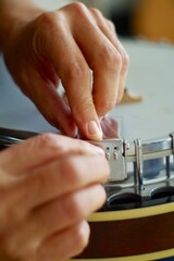 close up of a person changing strings on a banjo